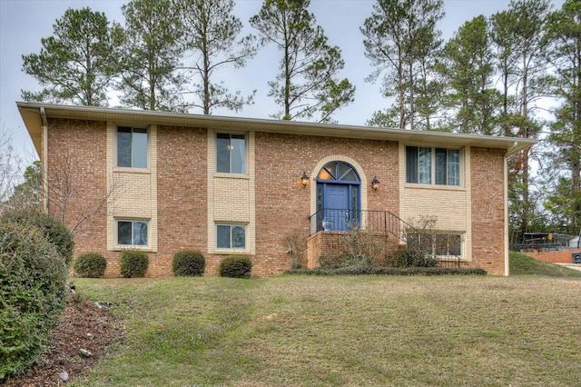 raised ranch with a front yard