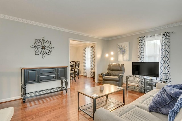 living room with wood-type flooring and ornamental molding