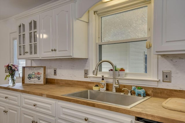 kitchen with white cabinetry, sink, and dishwasher