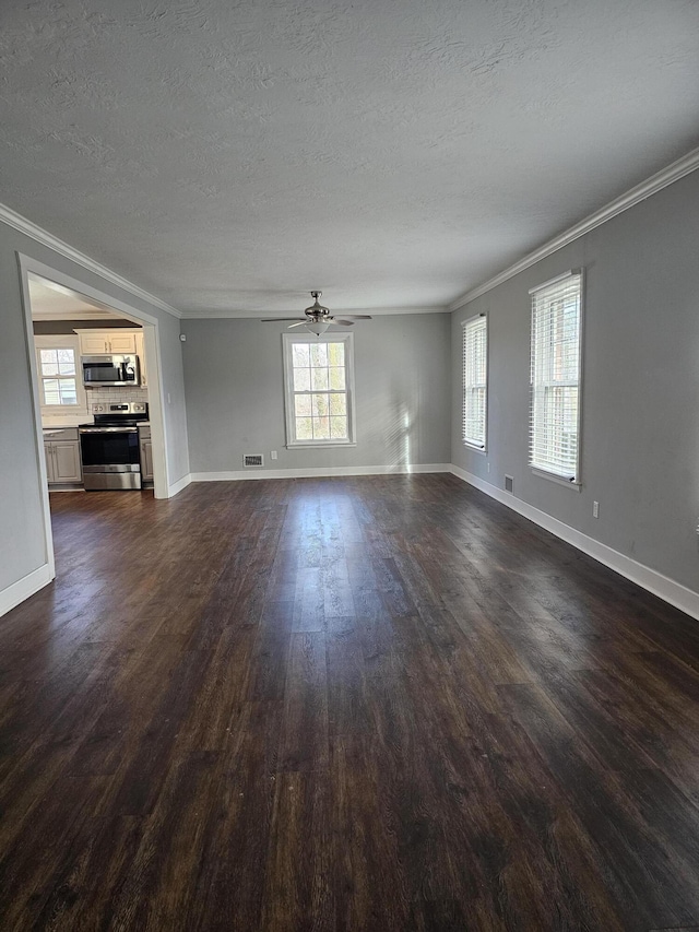 unfurnished living room featuring ceiling fan, ornamental molding, dark wood-type flooring, and a textured ceiling