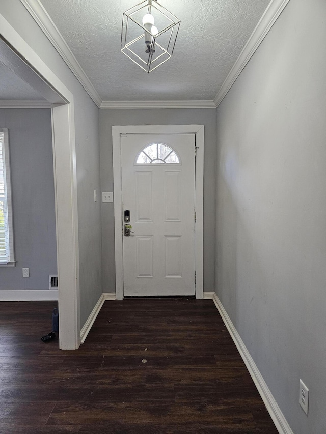 entryway featuring ornamental molding, dark wood-type flooring, and a healthy amount of sunlight