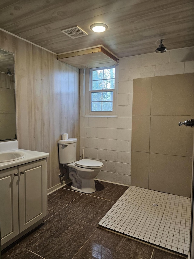 bathroom featuring wooden ceiling, vanity, toilet, and walk in shower