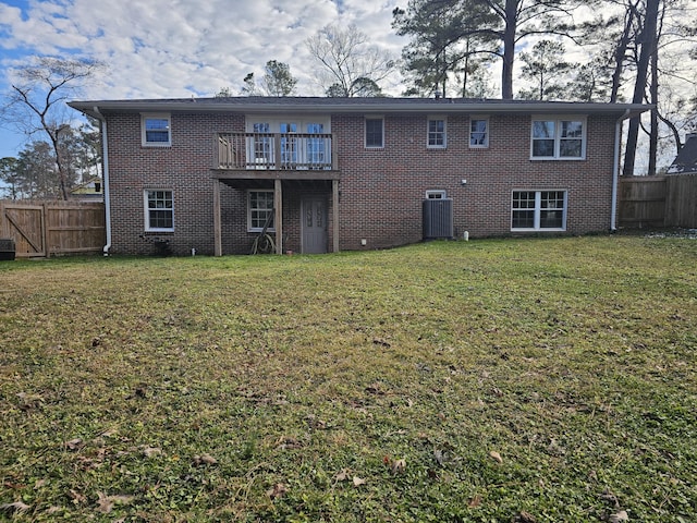 rear view of property with a yard and a deck