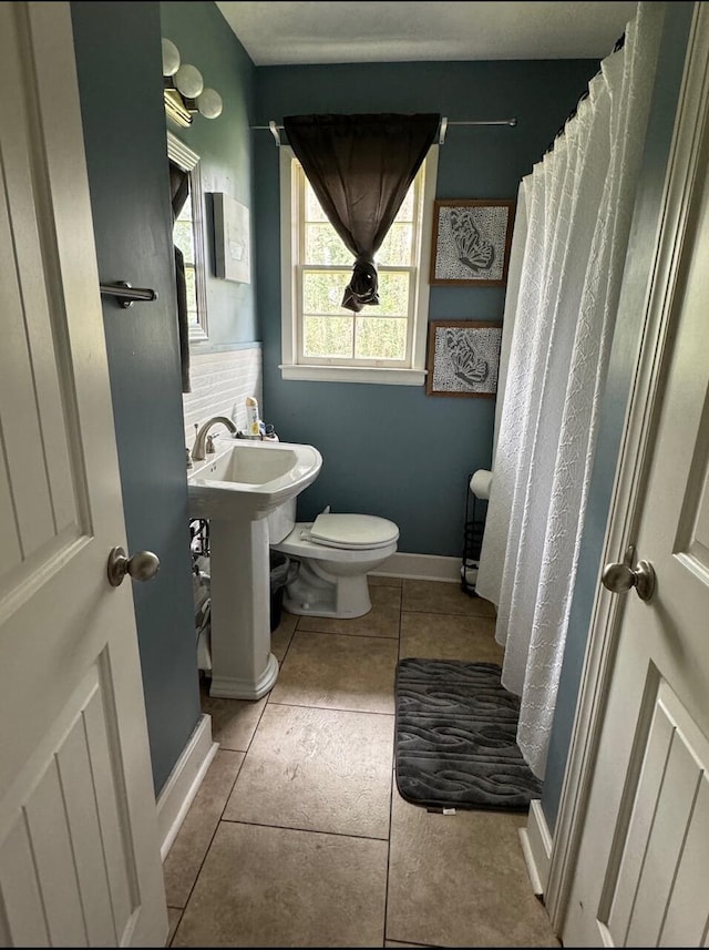 bathroom with sink, tile patterned flooring, and toilet