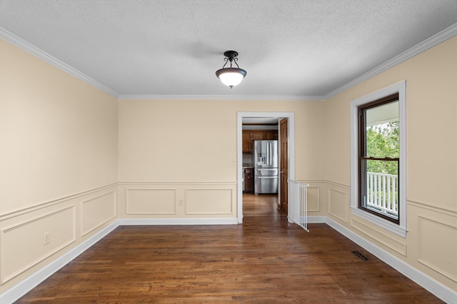 922 Windmill Ln, Evans, GA 30809 - empty room with ornamental molding, dark wood-style flooring, a decorative wall, and a textured ceiling