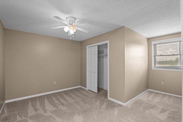 922 Windmill Ln, Evans, GA 30809 - unfurnished bedroom featuring a textured ceiling, carpet flooring, baseboards, a closet, and a ceiling fan