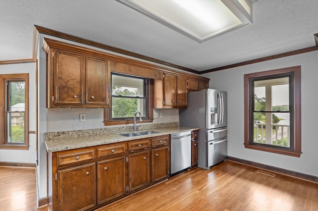922 Windmill Ln, Evans, GA 30809 - kitchen featuring stainless steel appliances, a sink, crown molding, light wood-type flooring, and baseboards