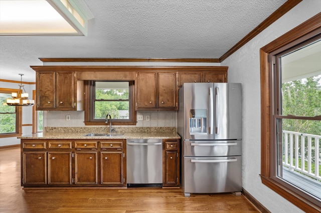 922 Windmill Ln, Evans, GA 30809 - kitchen with stainless steel appliances, a sink, ornamental molding, a textured ceiling, and wood finished floors