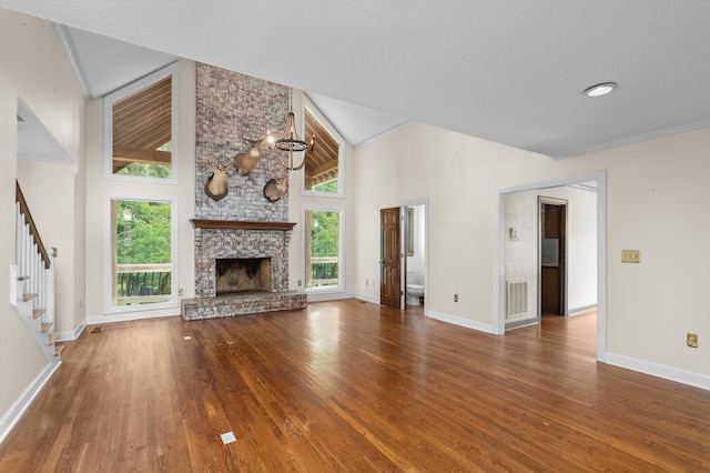 922 Windmill Ln, Evans, GA 30809 - unfurnished living room with plenty of natural light, wood finished floors, stairway, and high vaulted ceiling