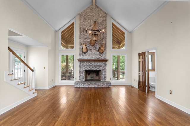 922 Windmill Ln, Evans, GA 30809 - unfurnished living room featuring a chandelier, high vaulted ceiling, plenty of natural light, baseboards, and crown molding