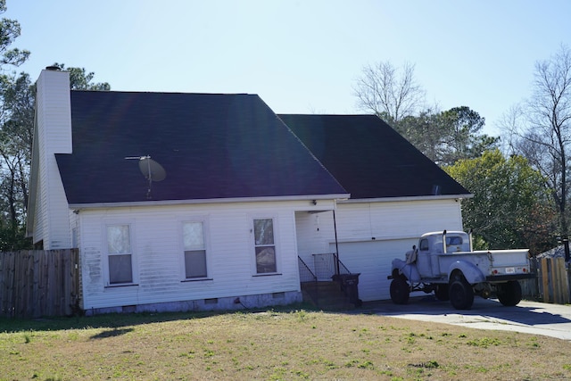 exterior space with crawl space, fence, a chimney, and concrete driveway