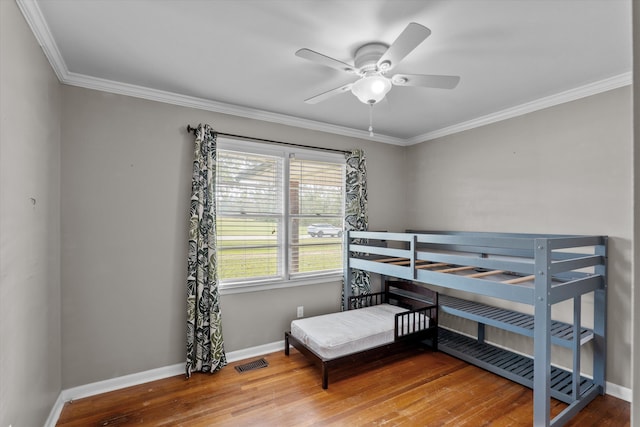 2872 Ga Highway 102, Wrens, GA 30833 - bedroom with ceiling fan, wood-type flooring, and crown molding
