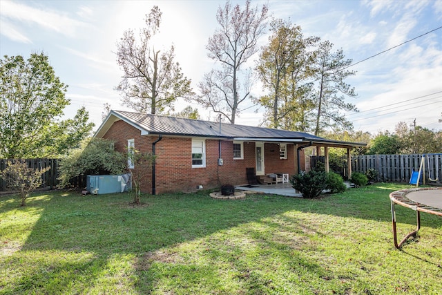 2872 Ga Highway 102, Wrens, GA 30833 - back of house featuring a patio area, a yard, a fire pit, and a trampoline