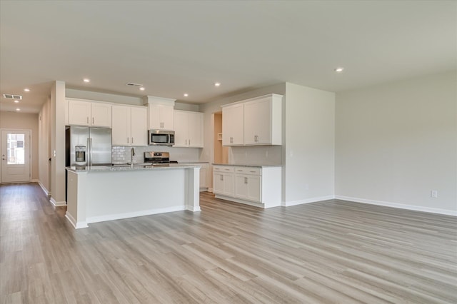 2015 Saylor Ln, Grovetown, GA 30813 - kitchen featuring appliances with stainless steel finishes, light wood-type flooring, tasteful backsplash, open floor plan, and recessed lighting