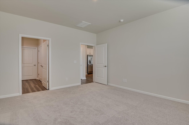 2015 Saylor Ln, Grovetown, GA 30813 - unfurnished bedroom featuring carpet, baseboards, stainless steel fridge, and connected bathroom