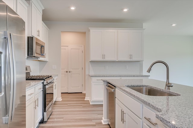 2015 Saylor Ln, Grovetown, GA 30813 - kitchen with stainless steel appliances, a sink, white cabinetry, light wood finished floors, and recessed lighting
