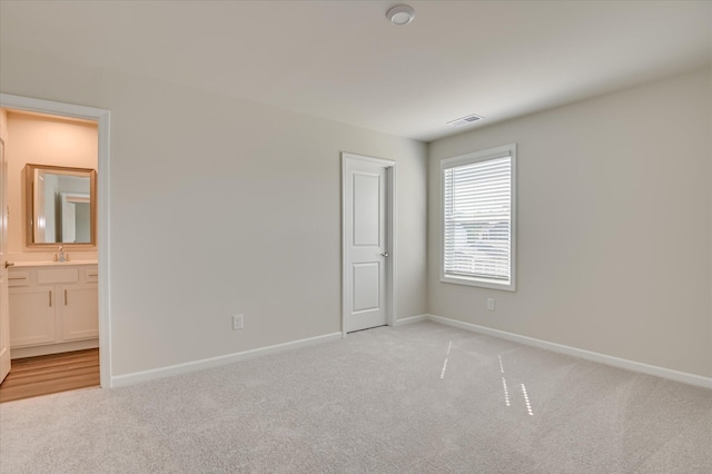 2015 Saylor Ln, Grovetown, GA 30813 - unfurnished bedroom with light carpet, baseboards, and a sink