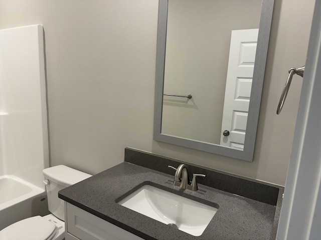 full bathroom with toilet and vanity