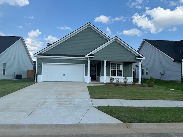 view of front of property featuring central AC, a front lawn, and a garage