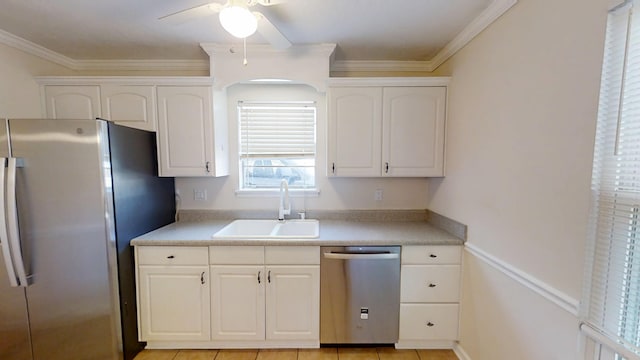 kitchen featuring a sink, crown molding, white cabinets, and stainless steel appliances