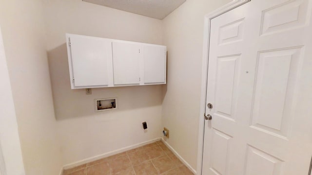 washroom with washer hookup, light tile patterned floors, cabinet space, and baseboards