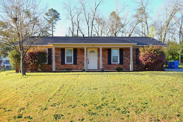 single story home featuring brick siding and a front lawn