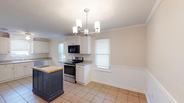 kitchen with appliances with stainless steel finishes, white cabinetry, crown molding, and a sink