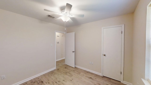 unfurnished bedroom featuring light wood finished floors, visible vents, ceiling fan, and baseboards