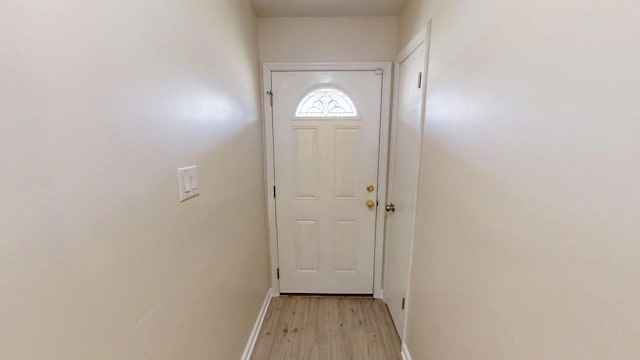 entryway with baseboards and light wood-type flooring