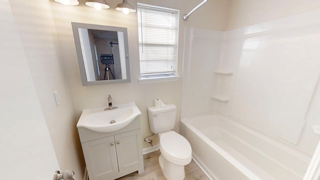 bathroom featuring shower / bathtub combination, toilet, vanity, and wood finished floors