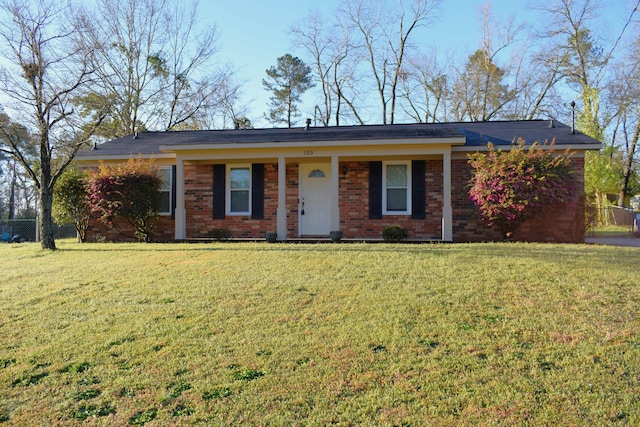 ranch-style house featuring brick siding and a front lawn