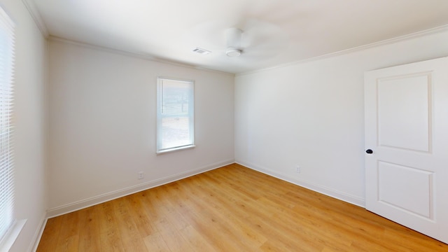 unfurnished room featuring ornamental molding, light wood-style floors, baseboards, and a ceiling fan