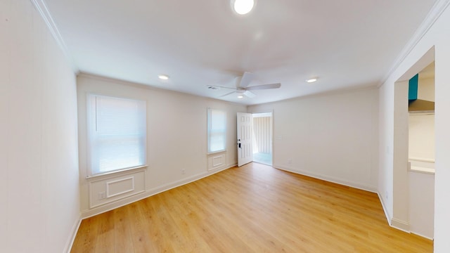 spare room featuring ornamental molding, light wood-style flooring, a ceiling fan, baseboards, and recessed lighting