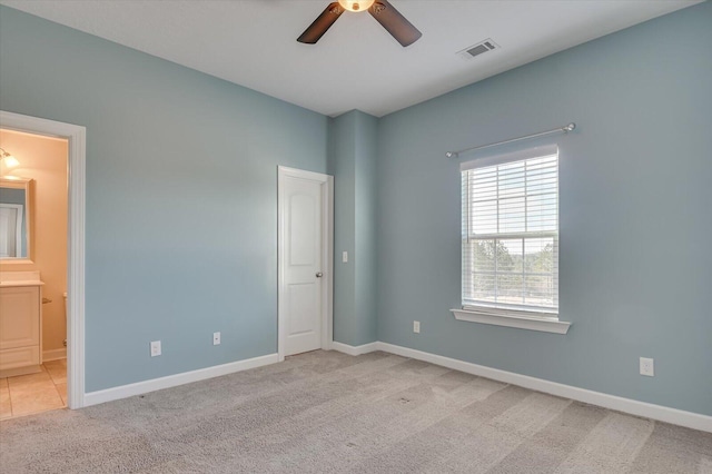 carpeted empty room featuring ceiling fan