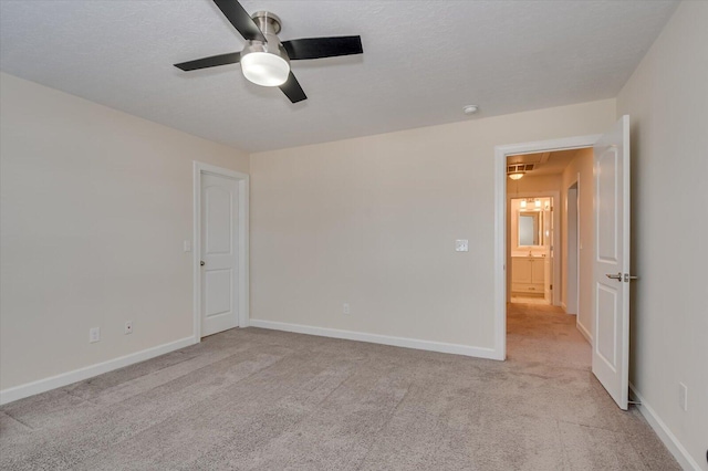 carpeted spare room with ceiling fan and a textured ceiling