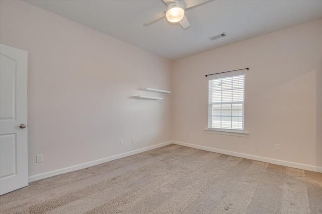 spare room with light carpet and ceiling fan