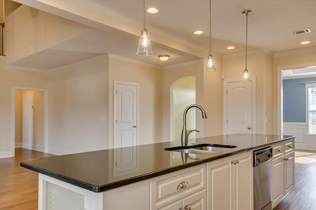 kitchen with sink, white cabinetry, a center island with sink, stainless steel dishwasher, and ornamental molding