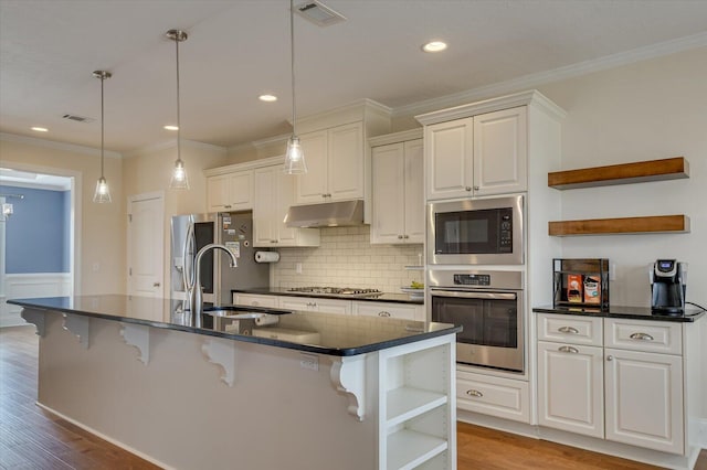 kitchen with appliances with stainless steel finishes, sink, and white cabinets