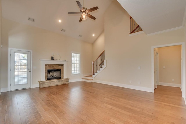 unfurnished living room with ceiling fan, high vaulted ceiling, and light hardwood / wood-style flooring