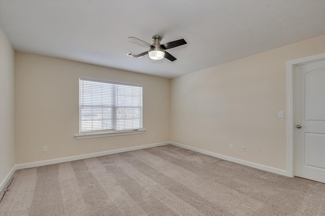 unfurnished room with ceiling fan and light carpet