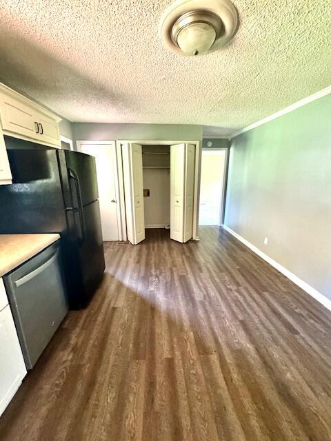 6183 Columbia Rd, Appling, GA 30802 - kitchen with dishwasher, dark wood-style floors, a textured ceiling, light countertops, and white cabinetry