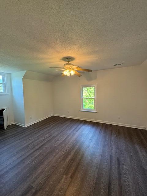 6183 Columbia Rd, Appling, GA 30802 - empty room featuring a textured ceiling, dark wood-type flooring, and ceiling fan