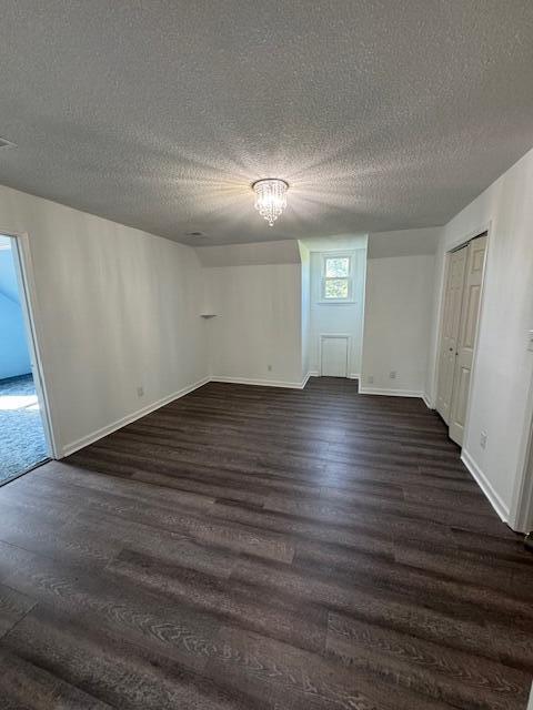 6183 Columbia Rd, Appling, GA 30802 - unfurnished bedroom with dark wood finished floors, a textured ceiling, and a chandelier