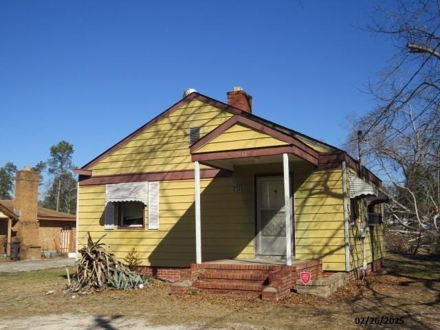 back of property featuring a chimney