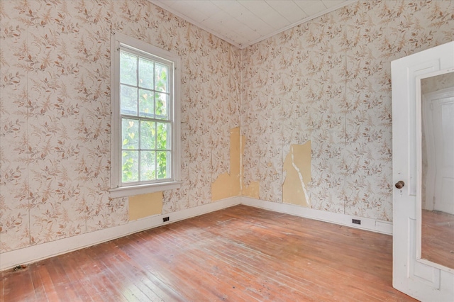 818 Academy Ave, Waynesboro, GA 30830 - unfurnished room featuring hardwood / wood-style flooring, crown molding, and wallpapered walls