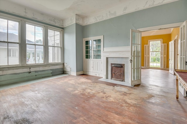 818 Academy Ave, Waynesboro, GA 30830 - unfurnished living room featuring hardwood / wood-style floors and a tile fireplace