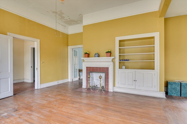 818 Academy Ave, Waynesboro, GA 30830 - unfurnished living room with wood finished floors, built in features, and a fireplace