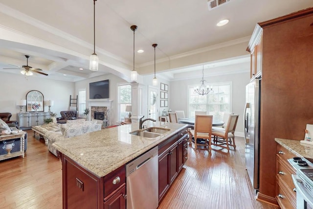 617 Morris Run, North Augusta, SC 29860 - kitchen featuring appliances with stainless steel finishes, a sink, a stone fireplace, ceiling fan, and hanging light fixtures