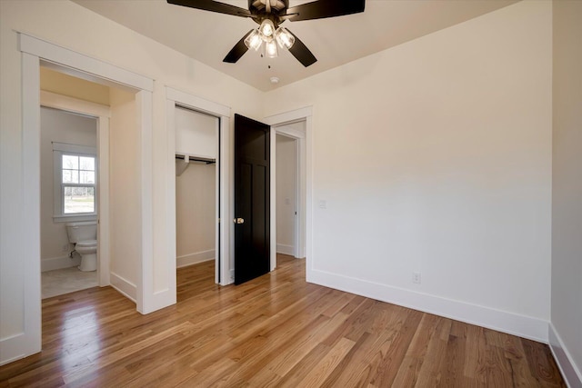 unfurnished bedroom featuring a closet, light hardwood / wood-style floors, ceiling fan, and ensuite bathroom