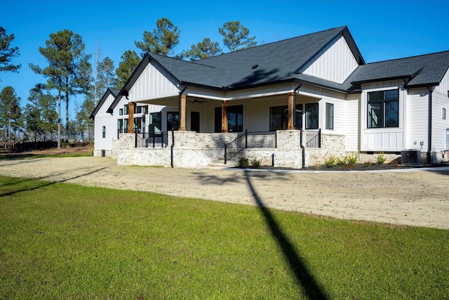 modern inspired farmhouse with cooling unit, a front lawn, and a porch